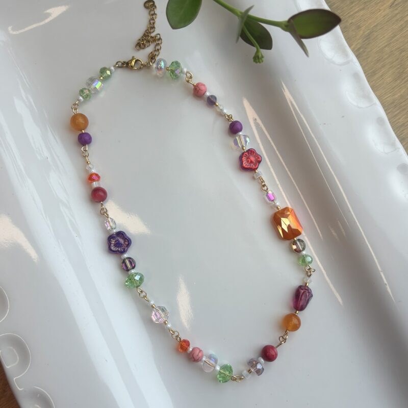 Anka purple flowers with orange, magenta, green beaded necklace
